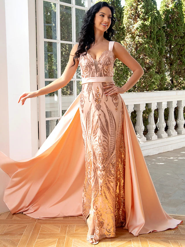 Woman wearing a glamorous dark mermaid trumpet evening gown with a V-neck and sequin slit.