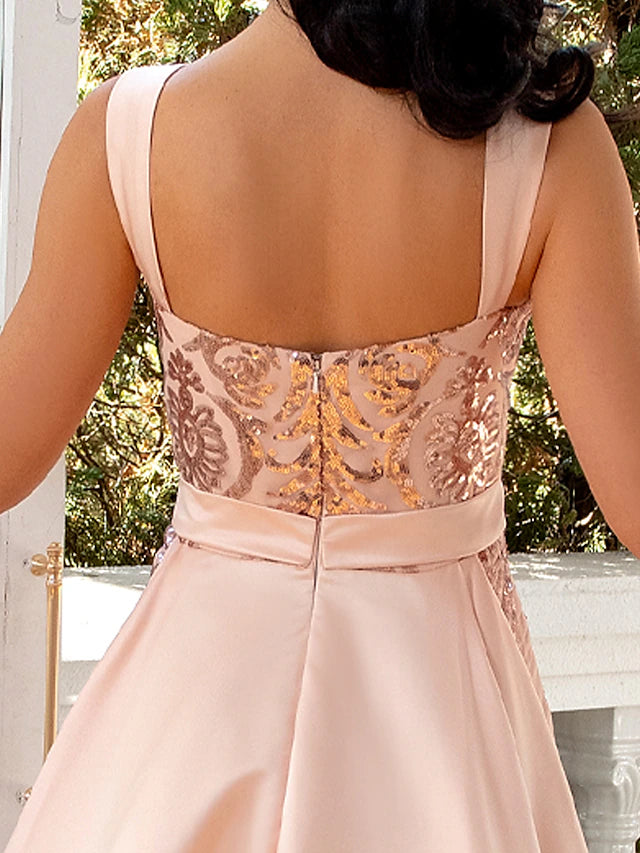 Side view of a woman in a dark mermaid trumpet dress, highlighting the V-neckline and elegant silhouette.