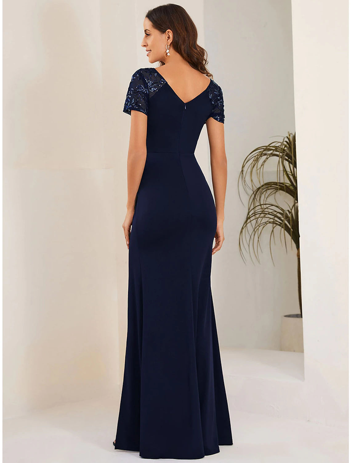 Full length view of the black mermaid trumpet dress with crystal embellishments.
