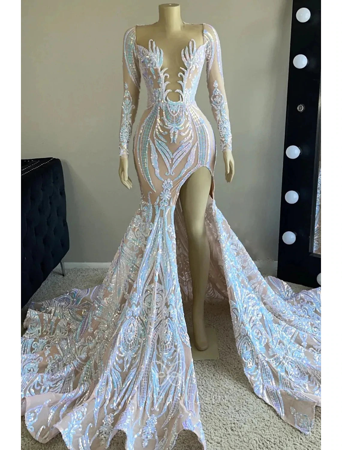 Glamorous mermaid evening gown with V-neck, long sleeves, and sequin embellishments.