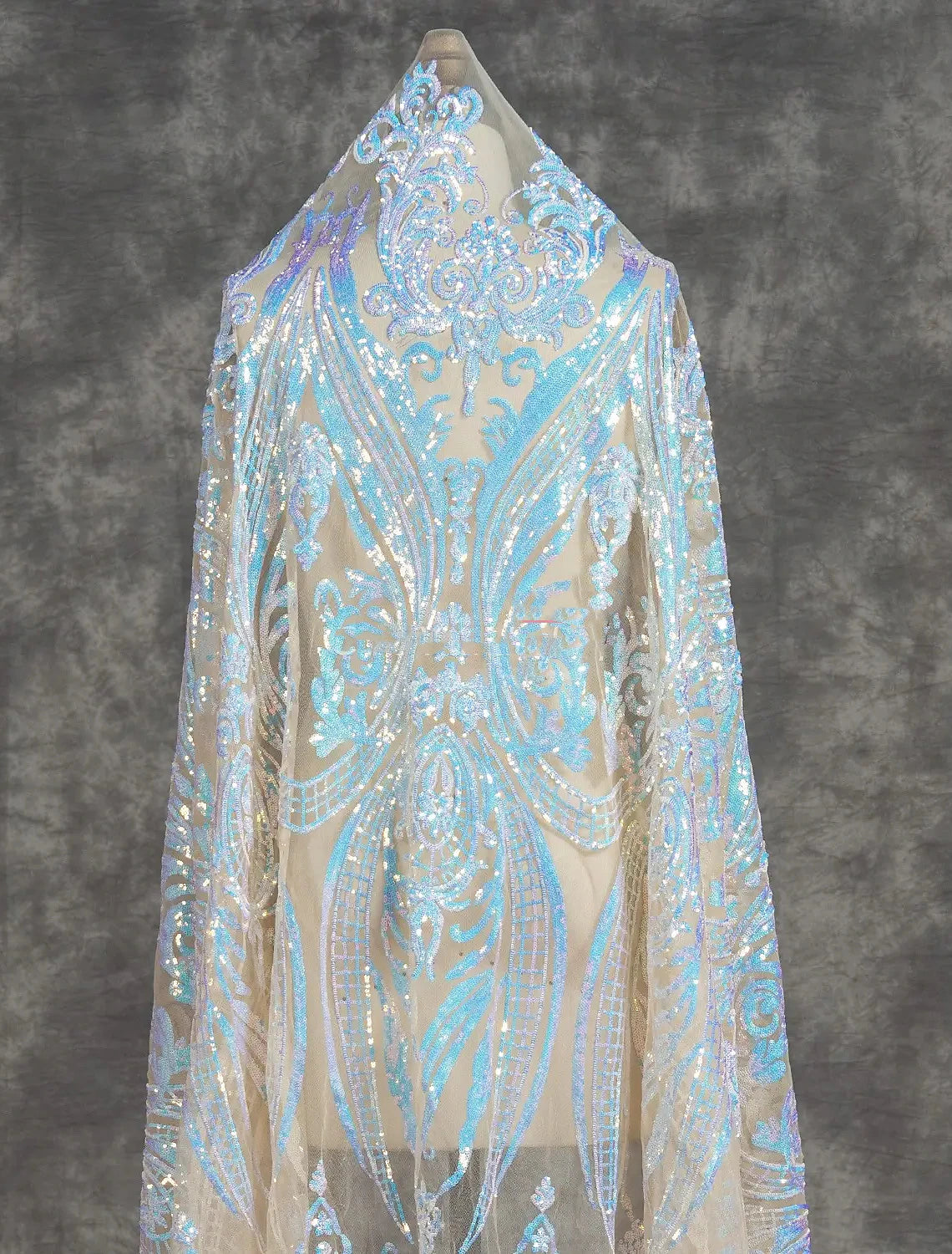 Close-up of the sequin detailing and high slit on the mermaid evening dress.