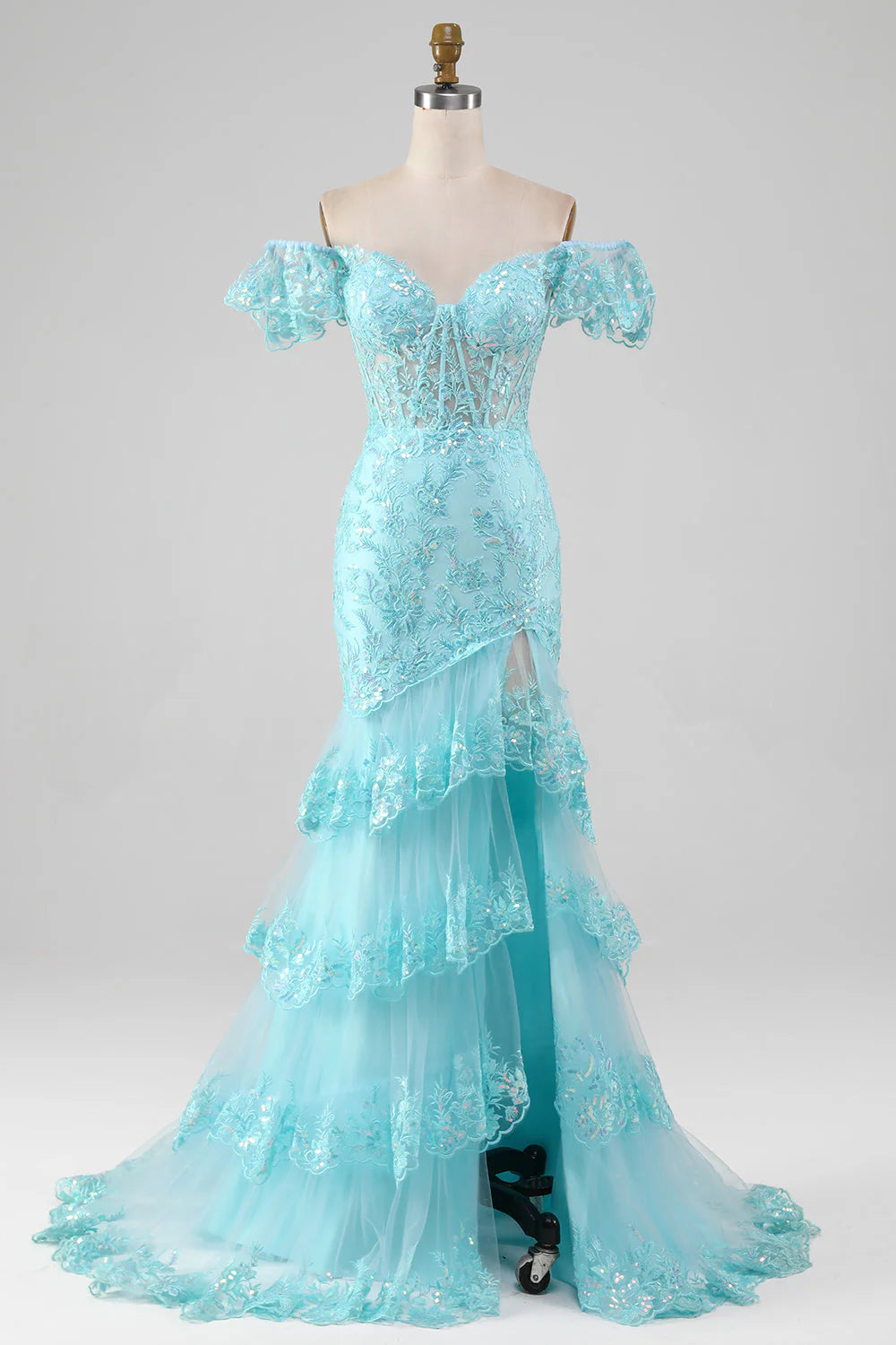 Model wearing a sky blue off-shoulder mermaid prom dress with lace and sequin details, featuring a high slit.