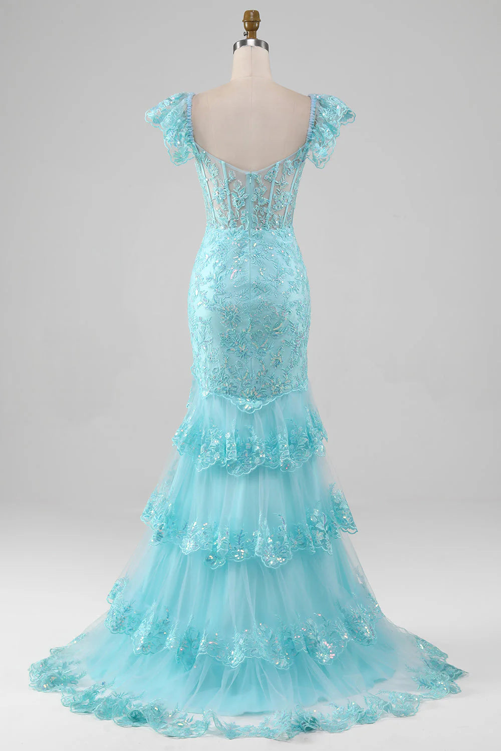 Model showcasing the back of a sky blue off-shoulder mermaid prom dress with lace and sequin embellishments.