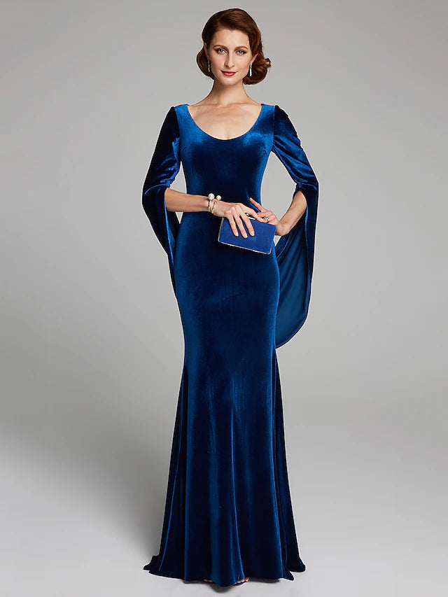 Woman wearing a dark velvet mermaid trumpet dress with long sleeves and scoop neck.