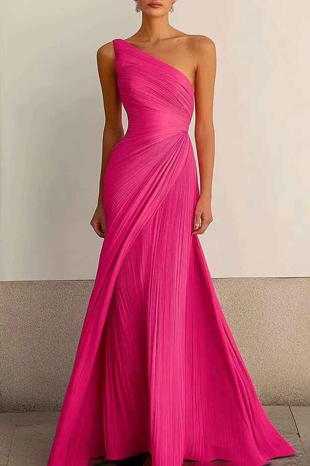 Woman wearing a glamorous one-shoulder ruched maxi prom dress.