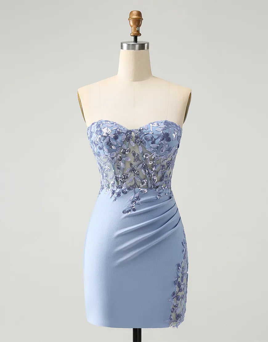Woman wearing a glamorous sequined applique corset maxi gown.