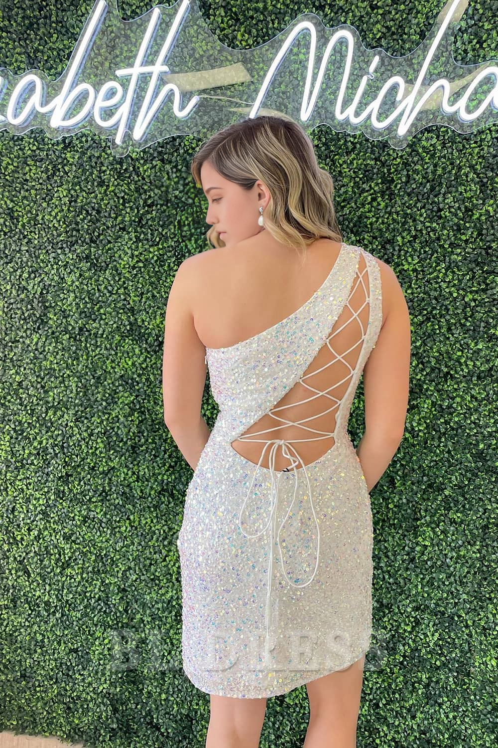 Back view of the sequin sheath dress, highlighting the intricate corset lacing.