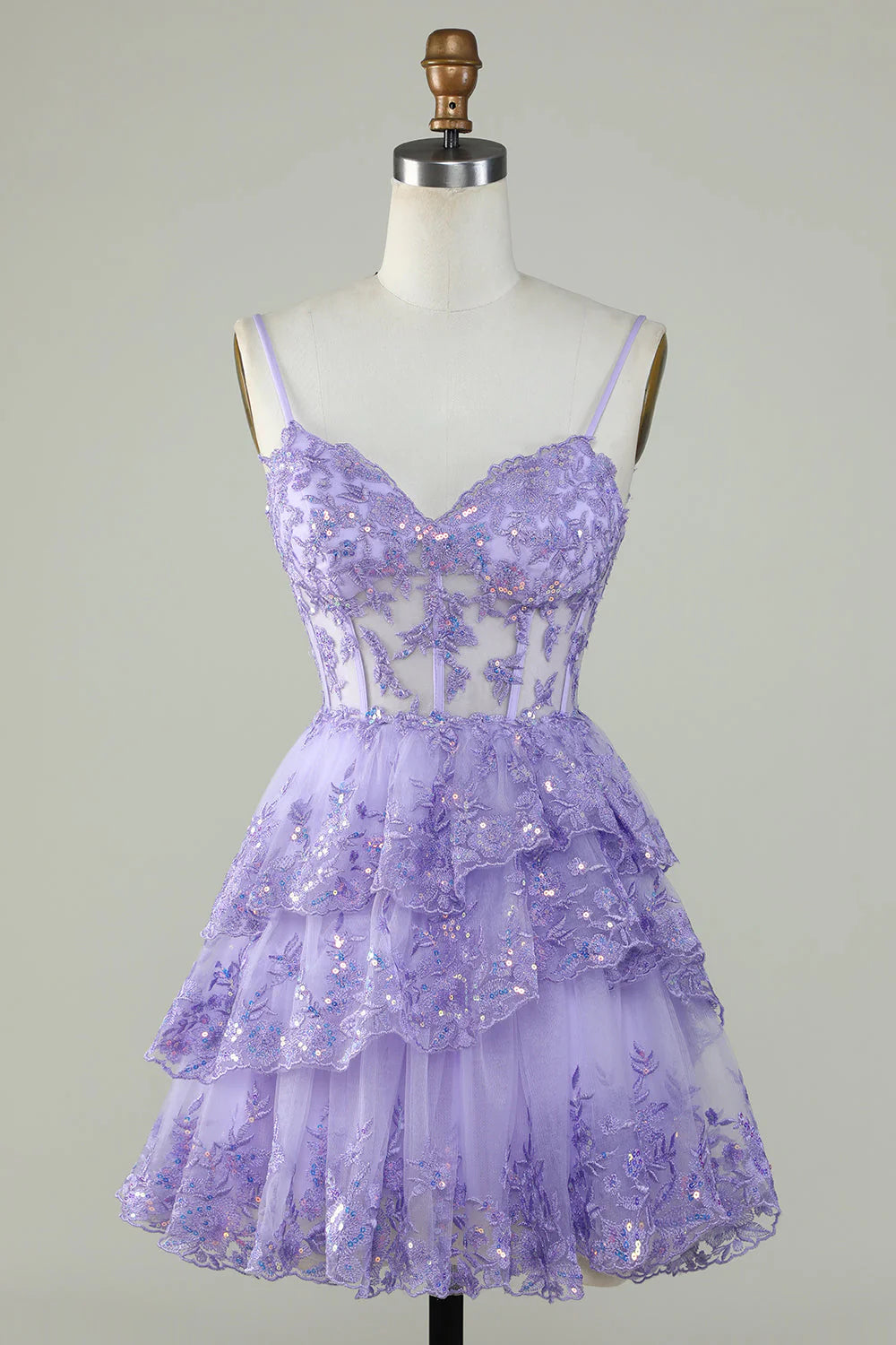 Model wearing a purple sparkly corset mini party dress with spaghetti straps.