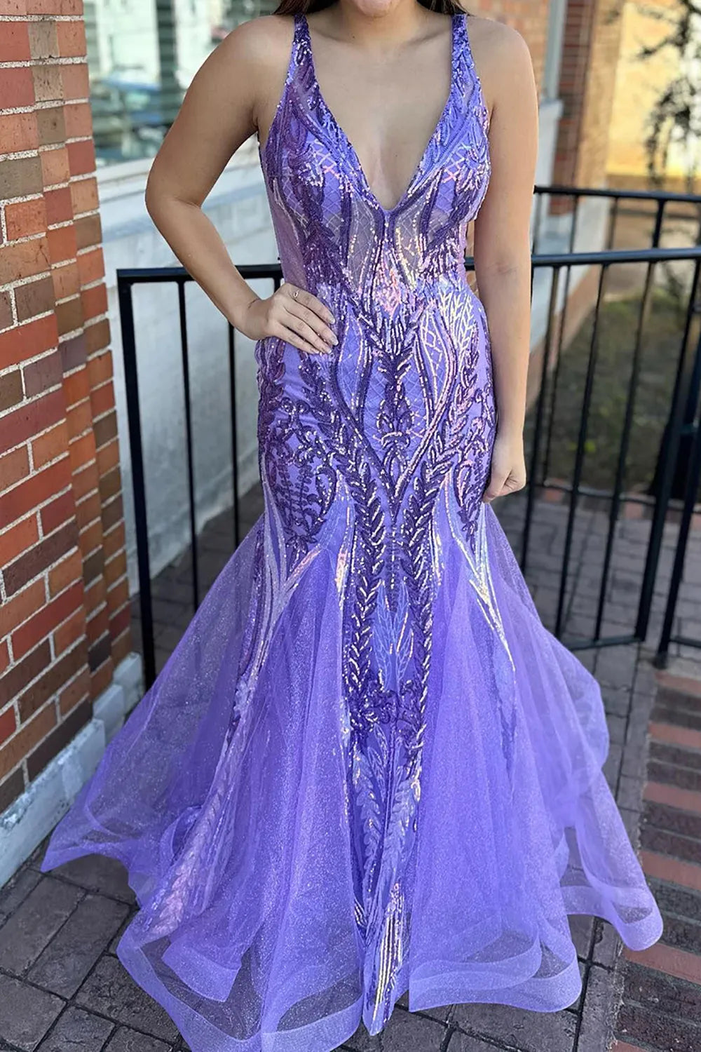 Sparkly mermaid prom dress with deep V-neck and sequins.