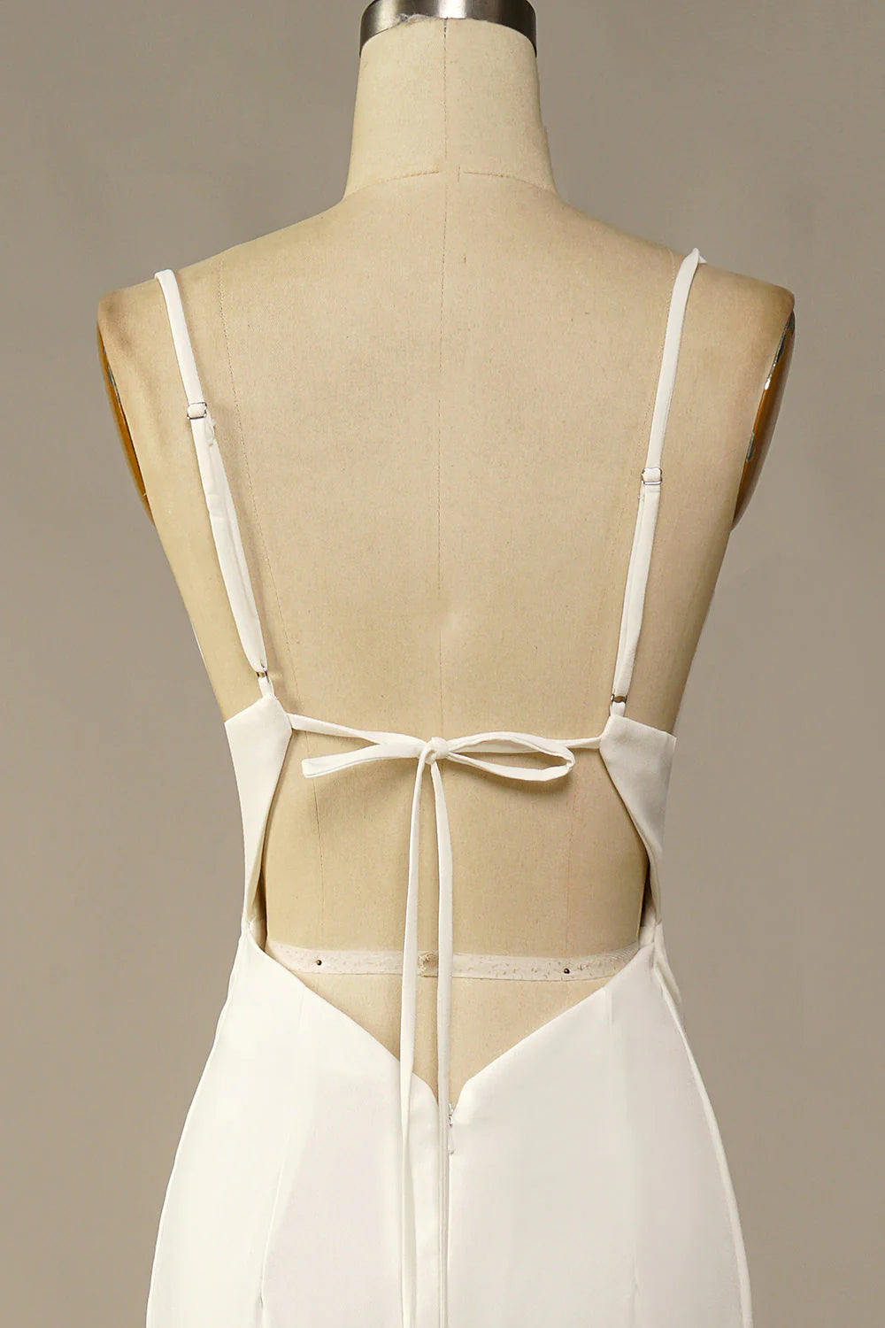 Side view of a bride wearing a white mermaid wedding dress.