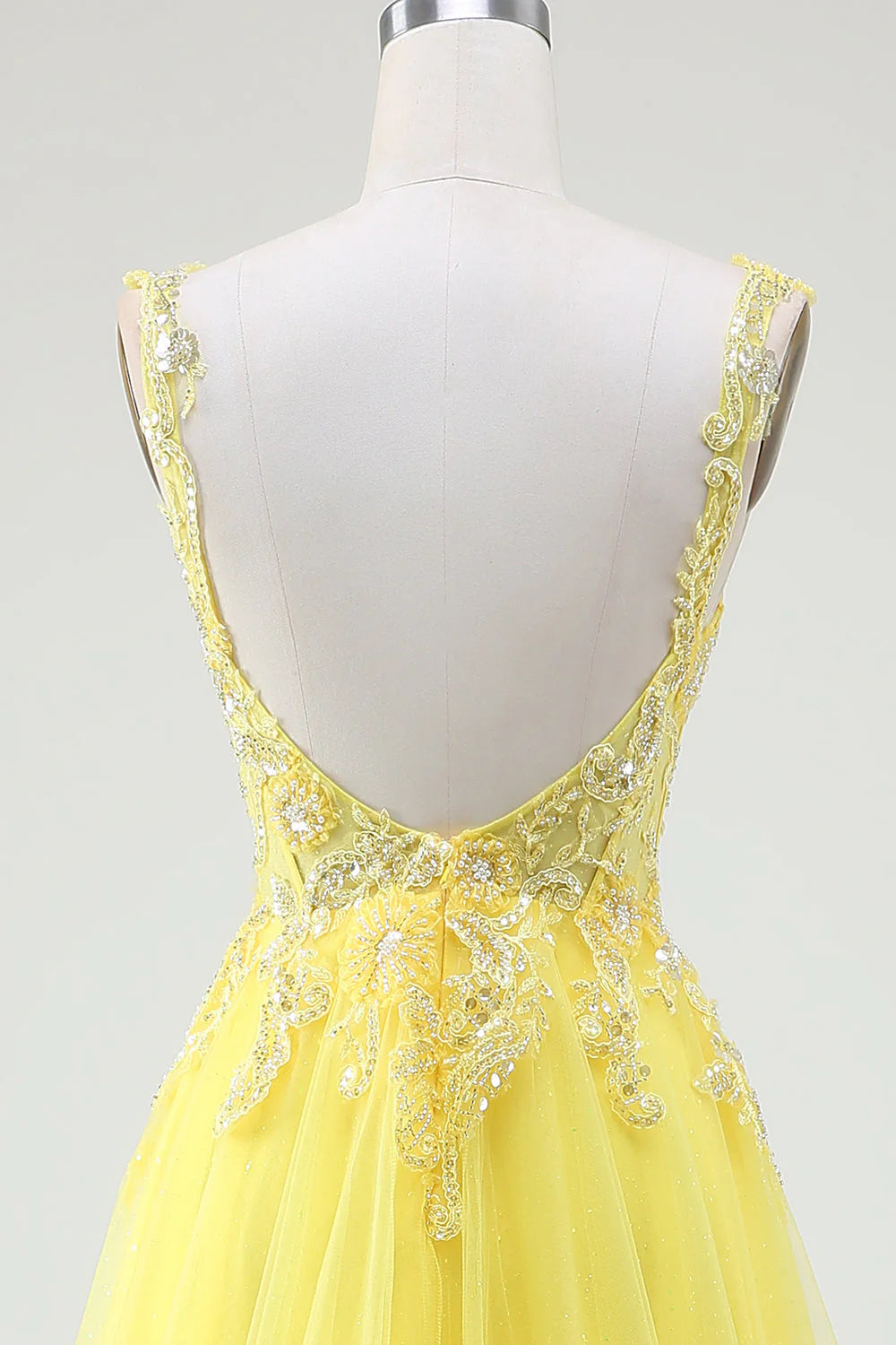 Close-up of the intricate beading on the corset bodice of the yellow prom dress.