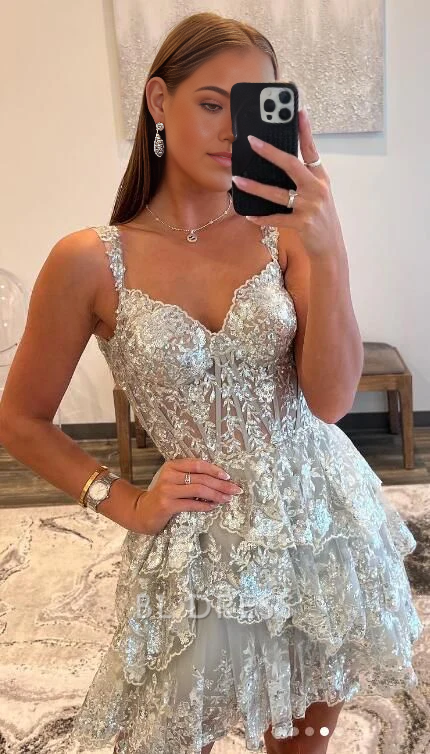 Woman wearing a short glitter A-line V-neck dress with appliques, suitable for formal events.