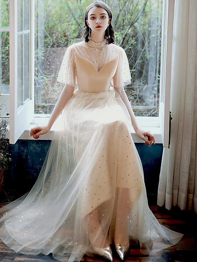 Side view of a model wearing a glittering A-line high neck half sleeve sequin tulle ankle length prom dress.