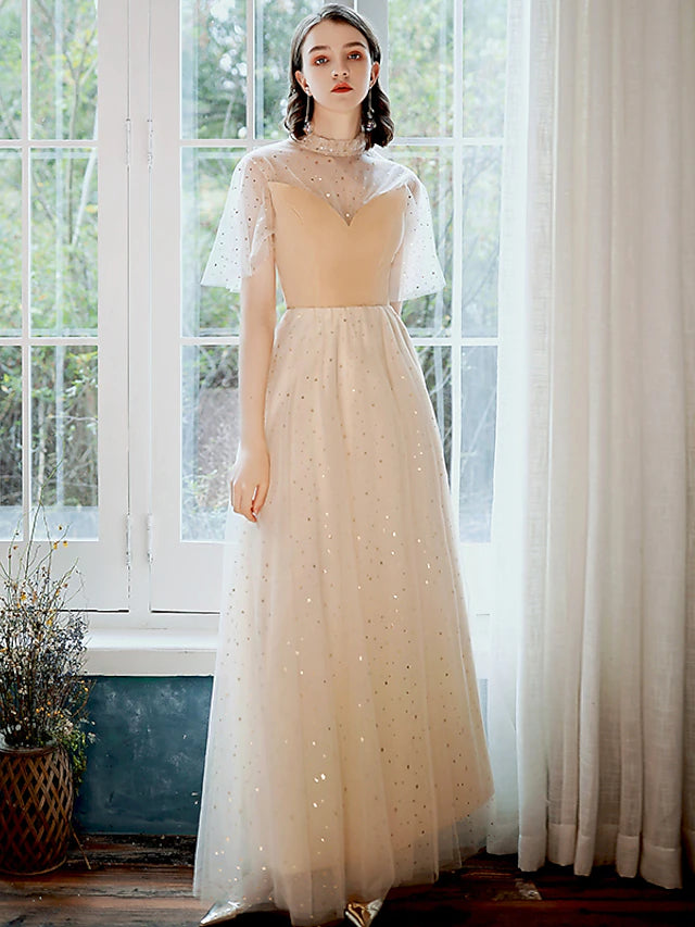 Back view of a model wearing a glittering A-line high neck half sleeve sequin tulle ankle length prom dress.