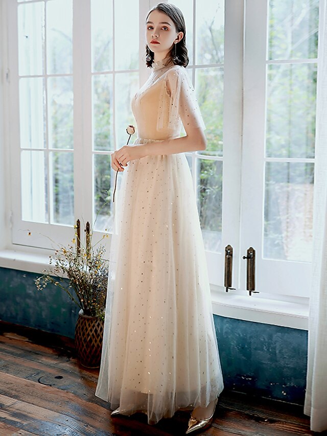 Close-up of the sequin and tulle fabric with pleats on the glittering A-line prom dress.