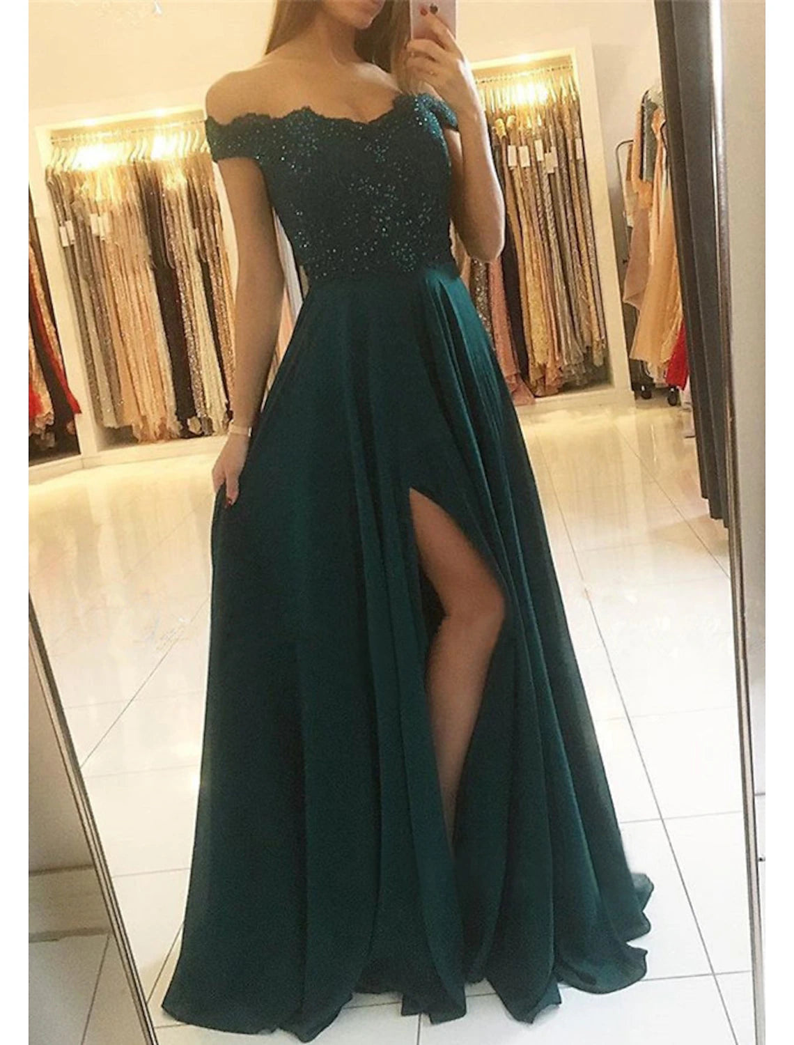 Back view of a glittering A-line off-shoulder prom dress.