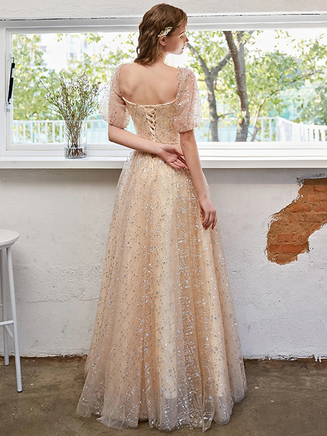 Model wearing a sparkling A-line formal dress with short sleeves.