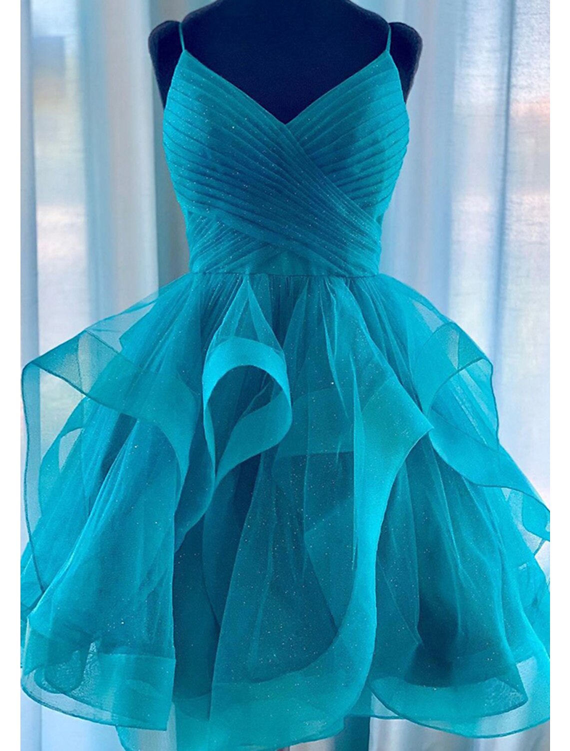 Back view of a sparkling A-line tiered plisse mini dress.