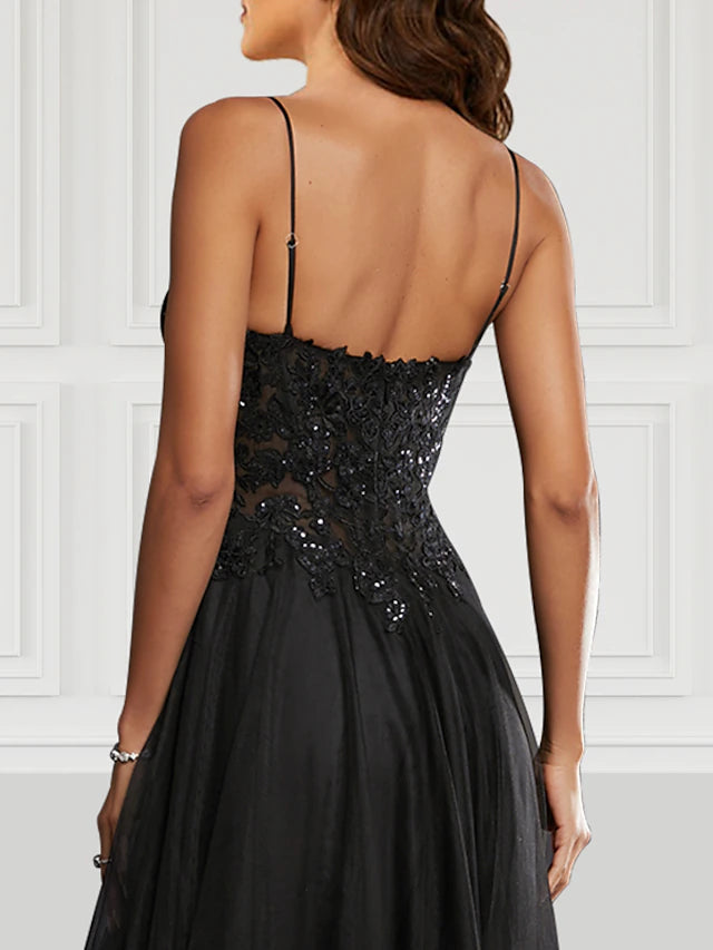 Side view of a black A-line glitter tulle prom dress, highlighting the elegant slit.