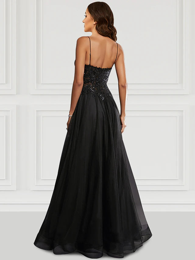 Back view of a black A-line glitter tulle prom dress with spaghetti straps.