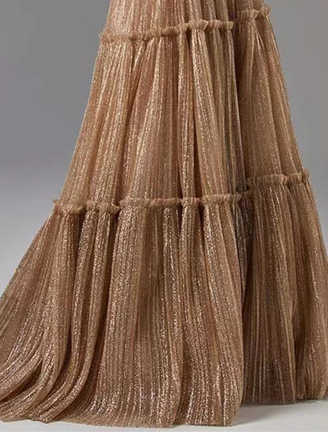 Woman showcasing the elegant drape of the glittering A-line gown.