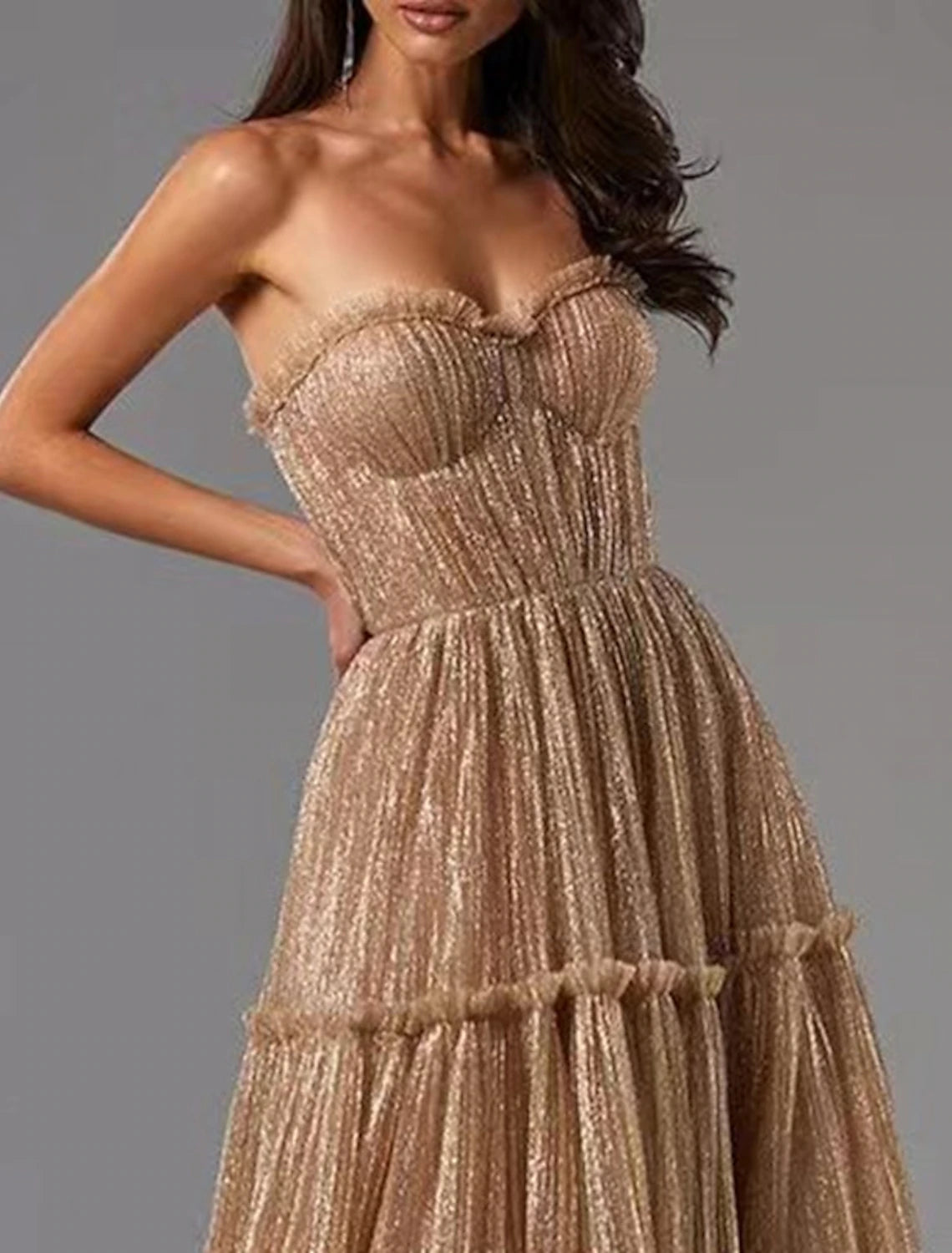 Full length view of the glittering A-line strapless dress.
