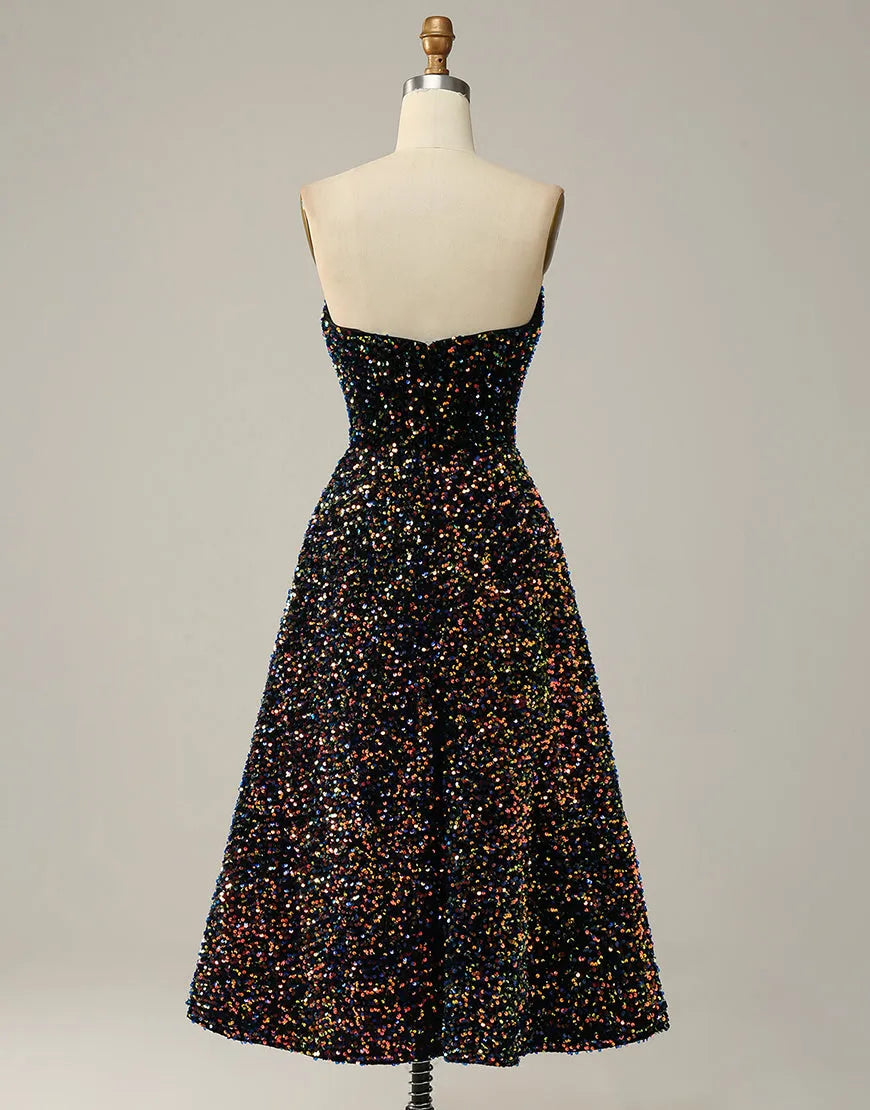 Model showcasing the back view of a black A-Line strapless glitter sequin tea length party dress.
