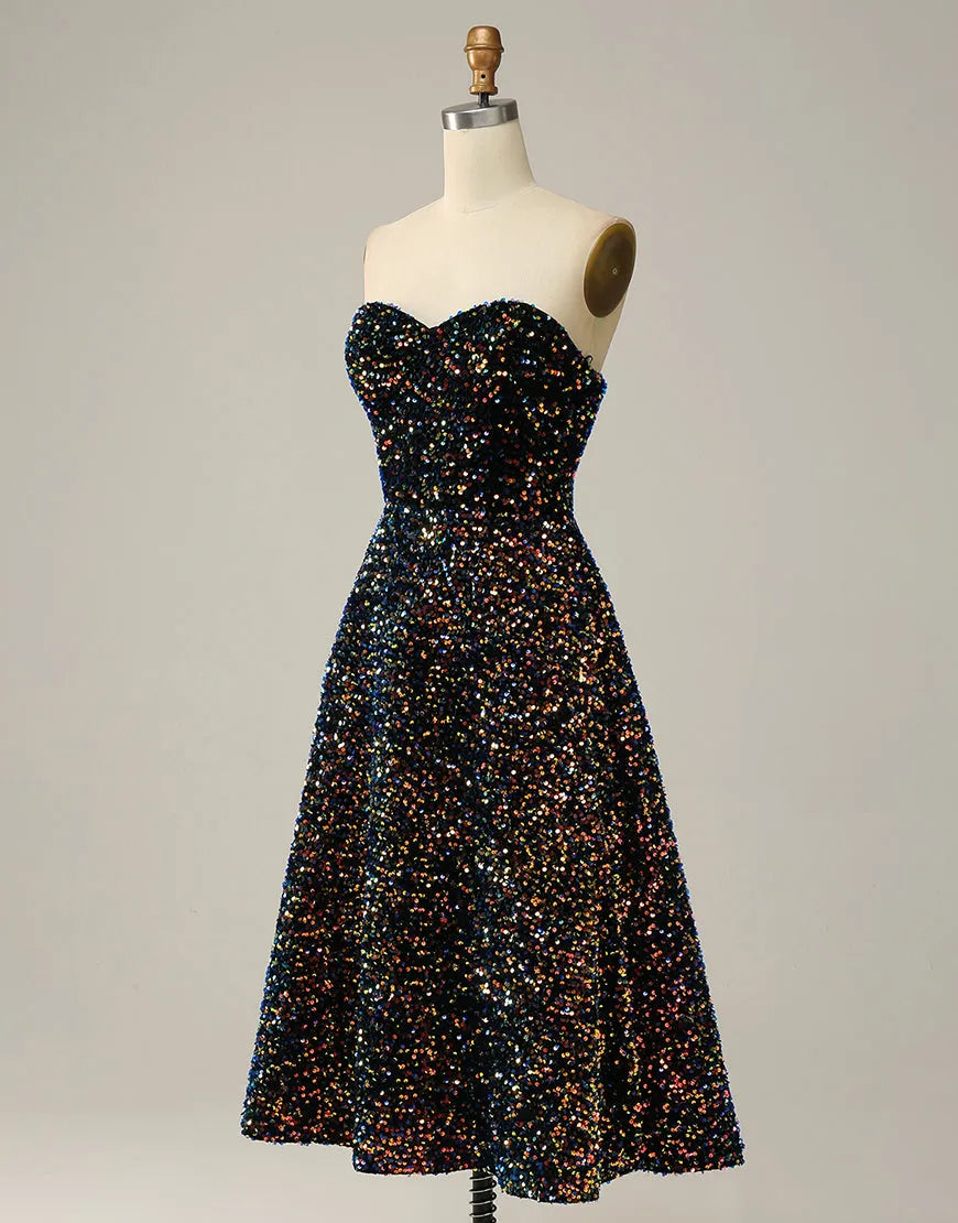Close-up of the glitter and sequin details on the black A-Line strapless tea length dress.