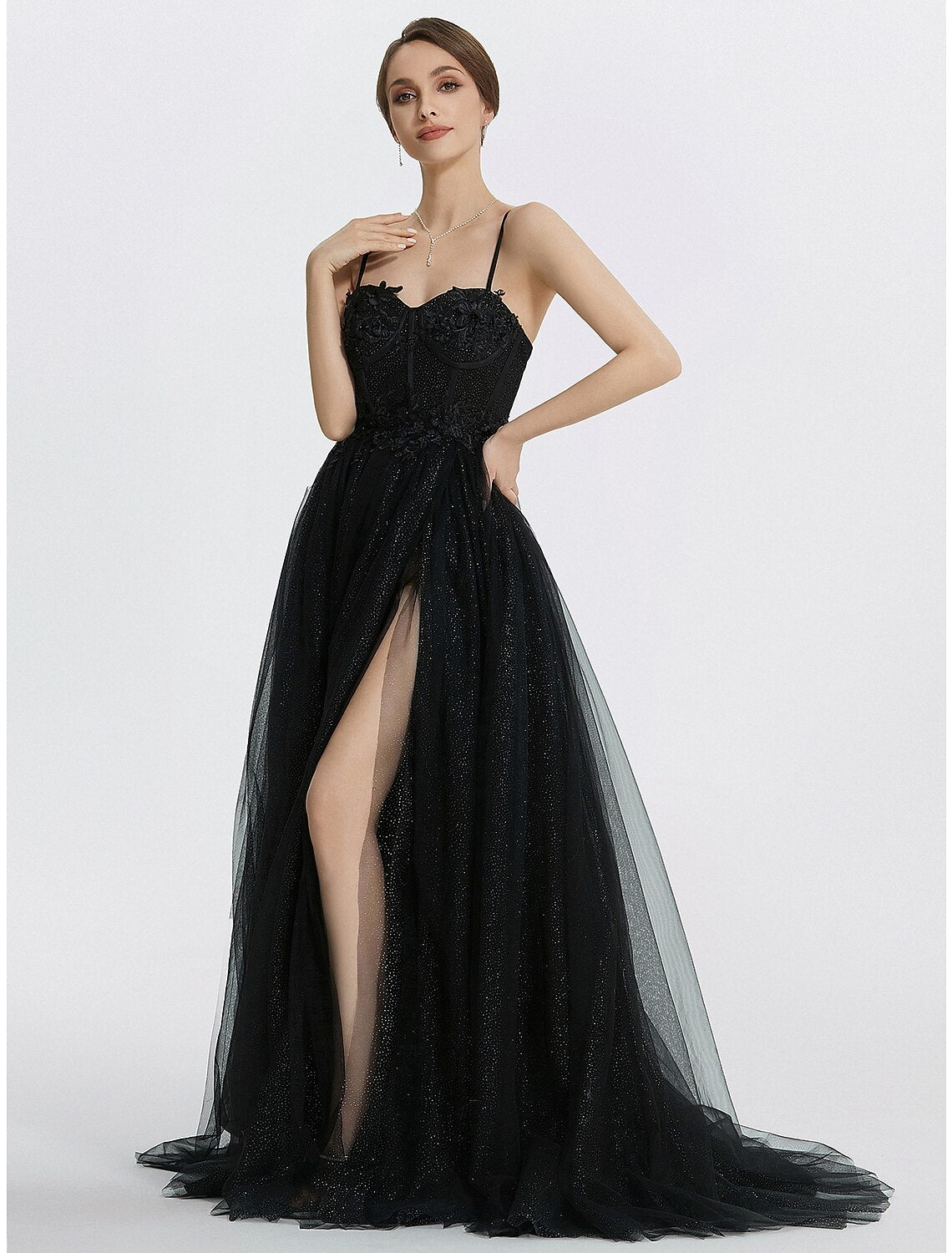 Close-up of the glittering tulle fabric and delicate appliques on the dress.