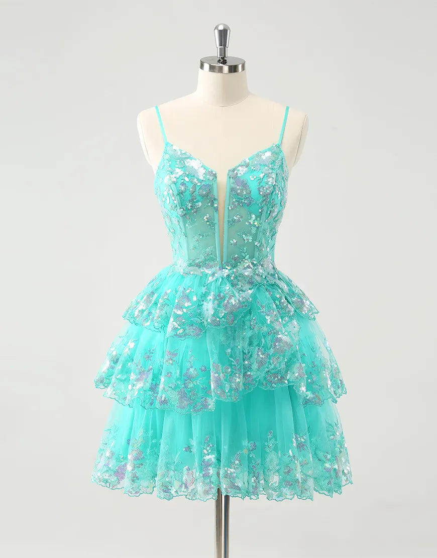 Model wearing a glittering A-line tiered sequined maxi homecoming dress.