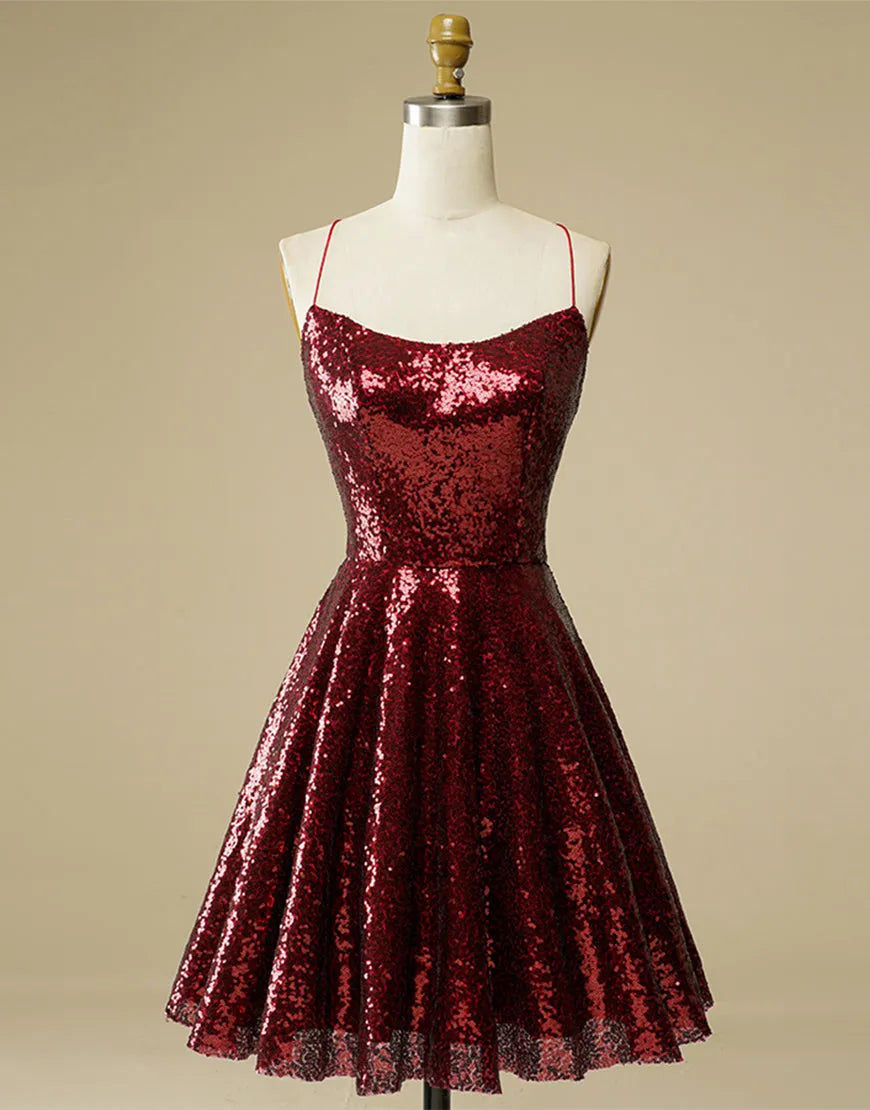 Woman wearing a glittering A-line sequin dress with a V-neck and lace-up back.