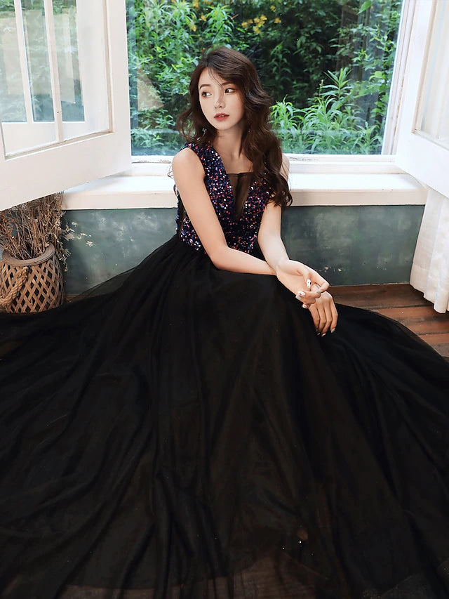 Model wearing a glittering A-line V-neck sequined floor-length dress.
