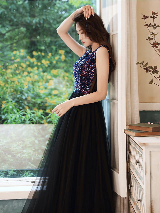 Side profile of the model in the elegant V-neck sequined gown.