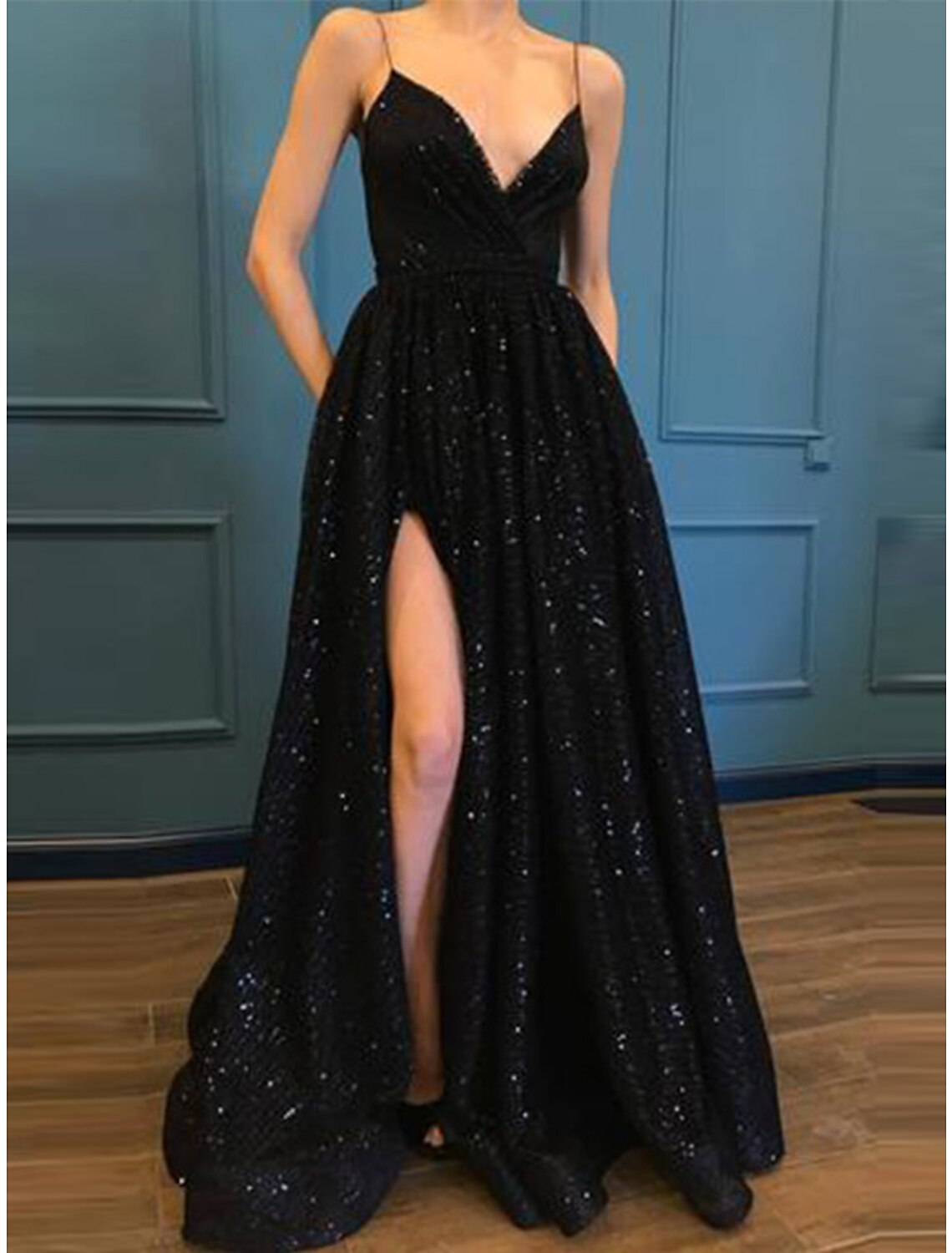 Back view of a woman in a floor-length sequined A-line party dress.