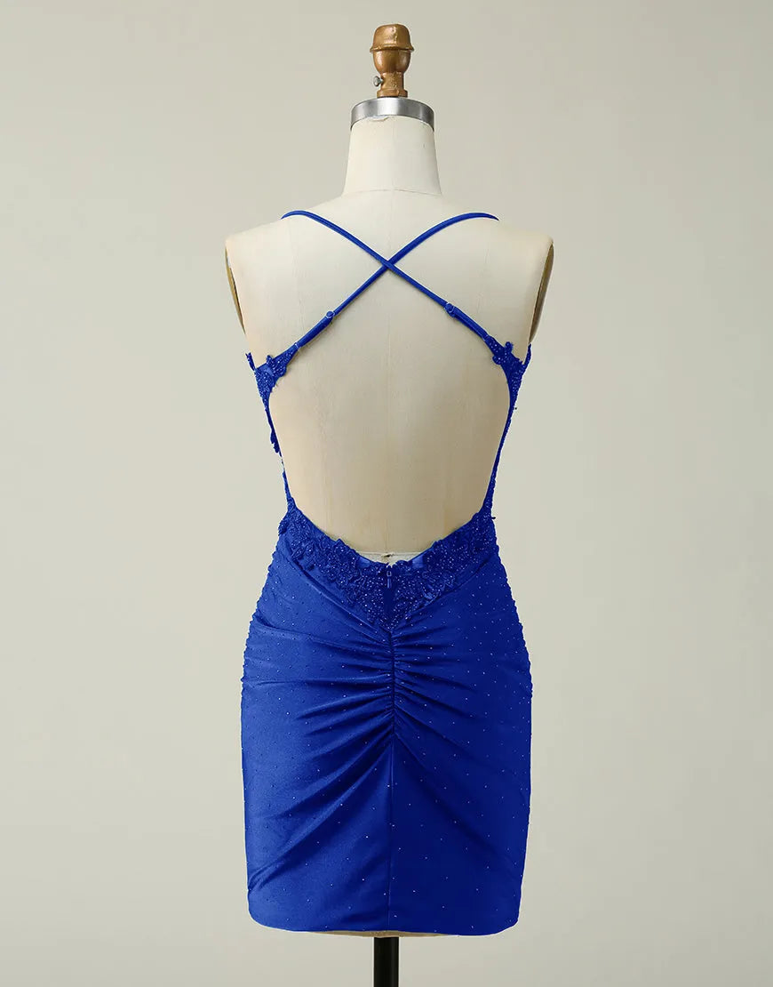 Back view of a short glitter dress featuring spaghetti straps and a cross-back design.