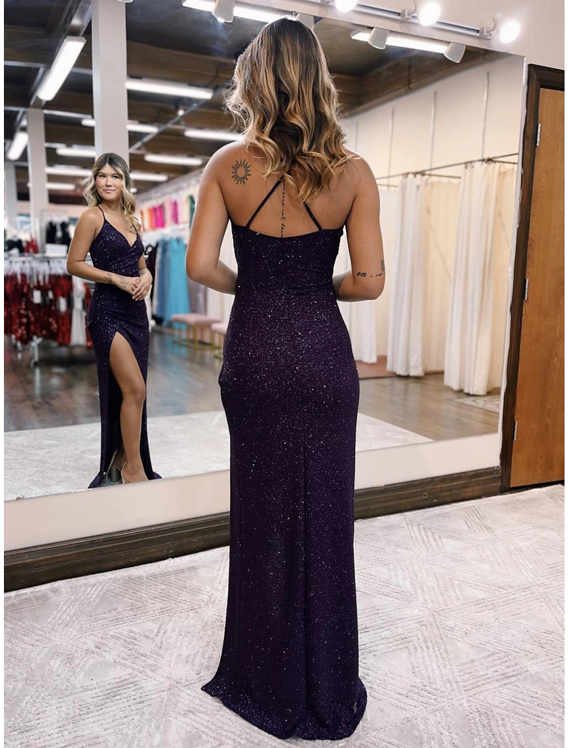 Close-up of the V-neckline and glittering satin fabric on the mermaid trumpet prom dress.