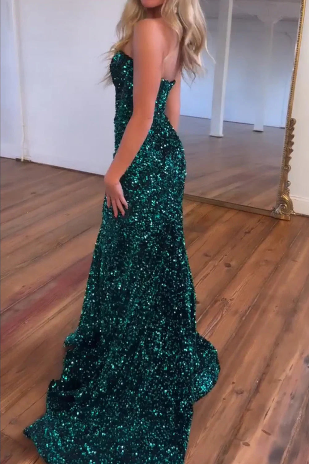 Close-up of the dark green glitter sequin fabric on a mermaid prom dress.
