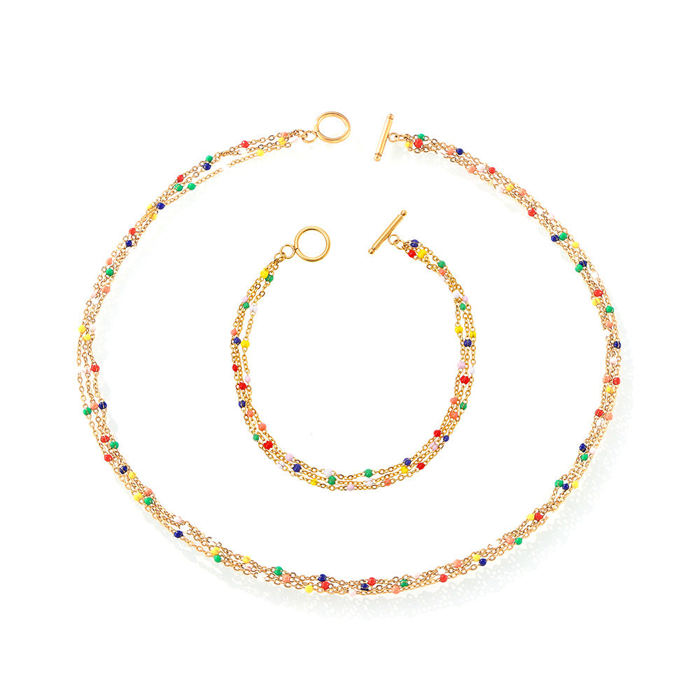 Close-up of a gold-plated titanium steel multi-layer necklace on a model.