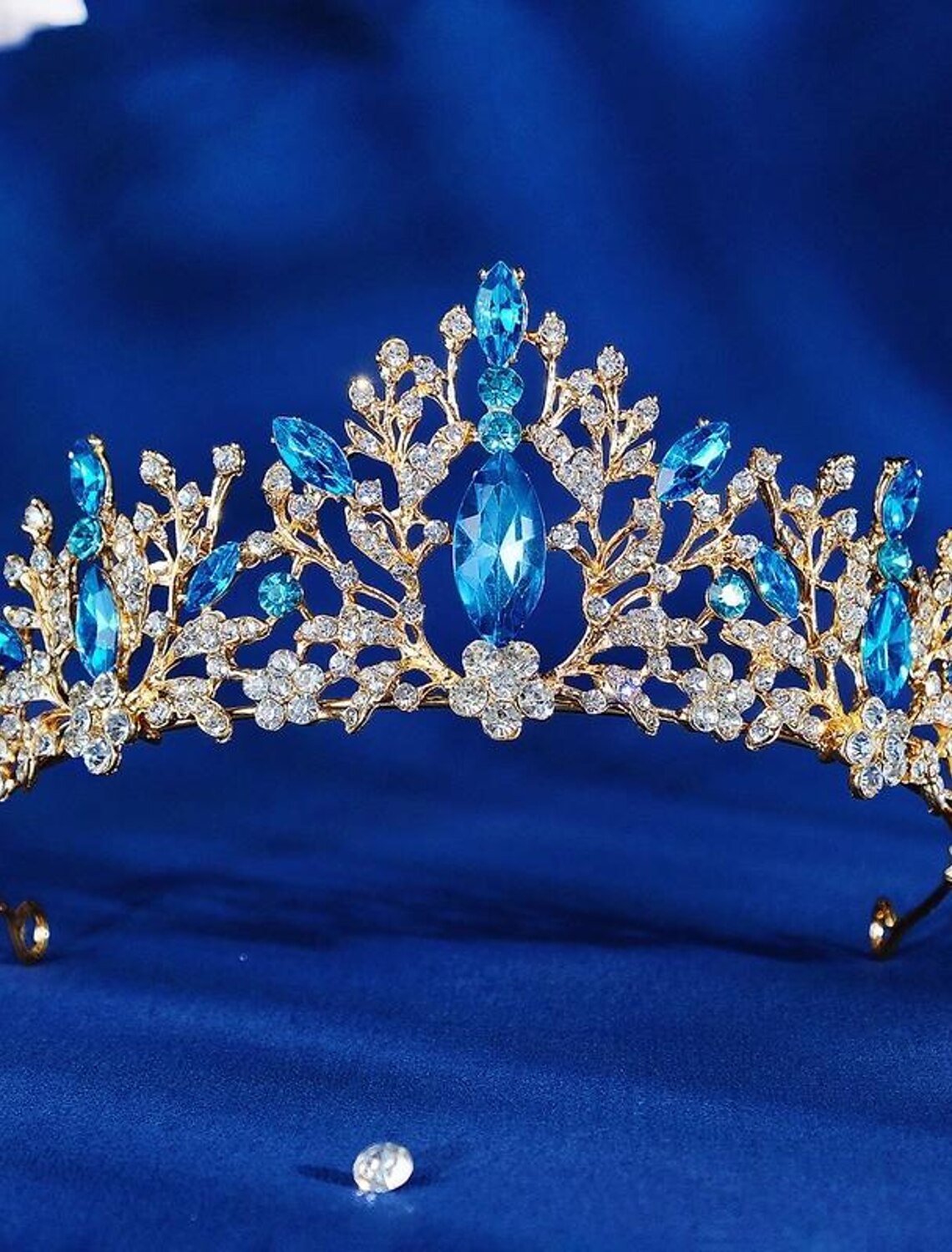 Close-up of golden crystal tiara with intricate details.