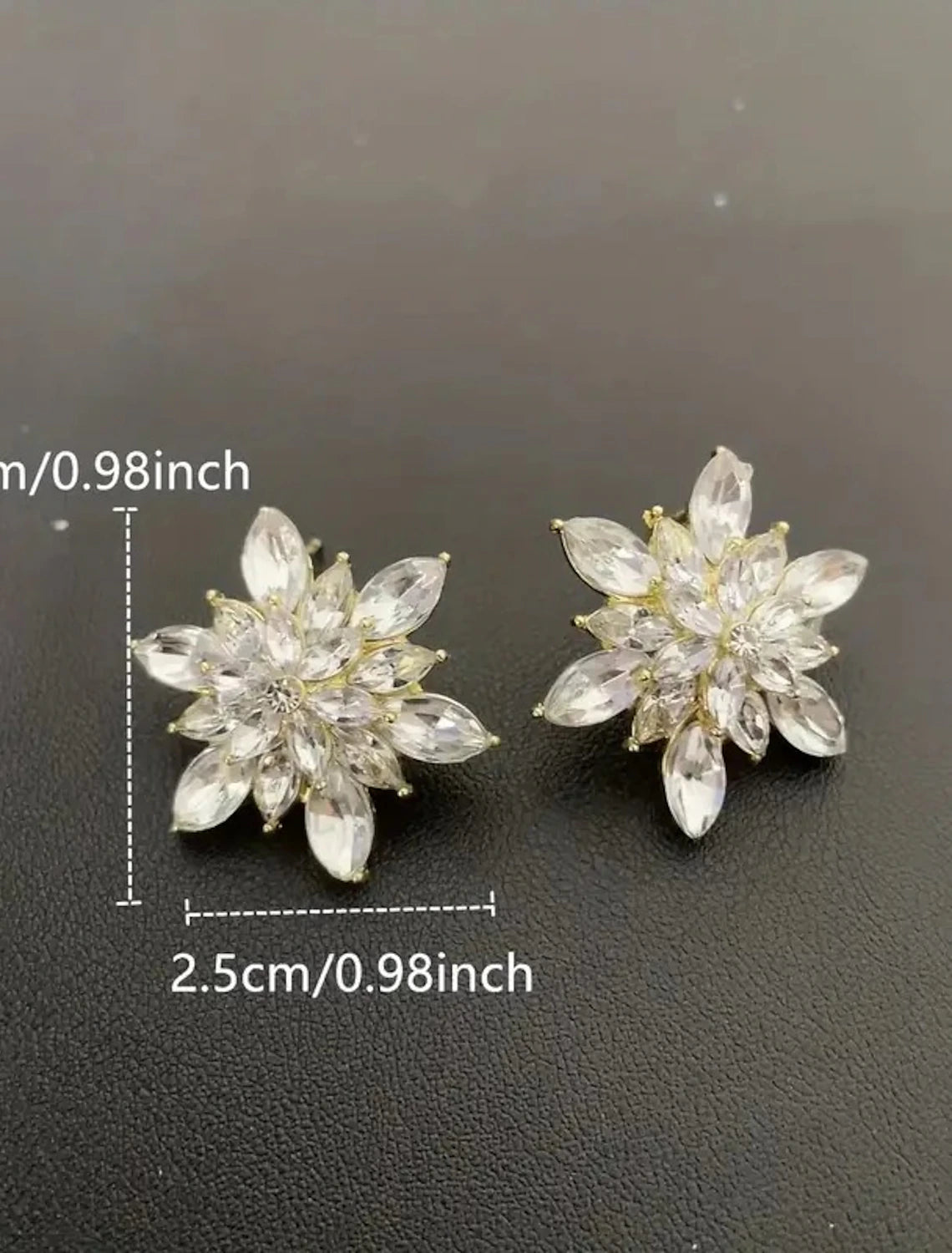 Close-up of a golden flower stud earring.