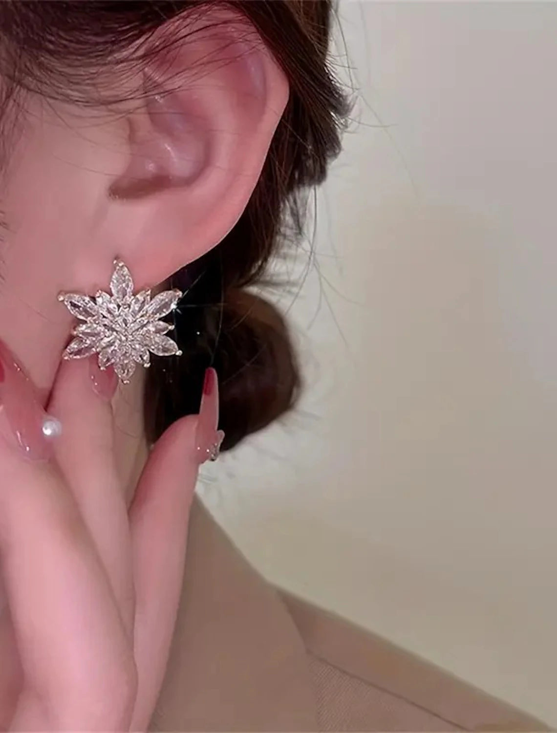 Golden flower stud earring with a clear background.