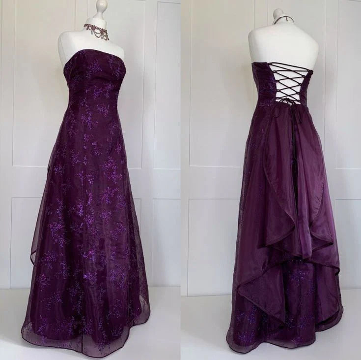 Dark purple strapless A-line maxi dress with sequin floral jacquard, lace-up back, and cascading ruffles.