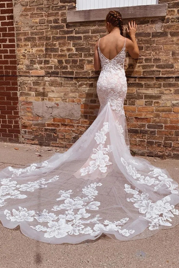 Close-up of intricate appliques on a mermaid wedding dress.