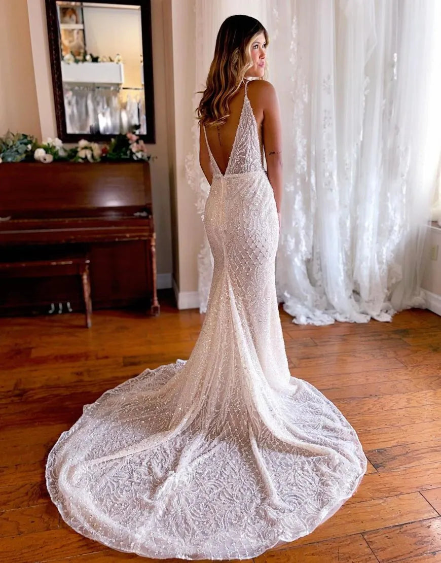 Mermaid deep V-neck glitter wedding dress, side view.
