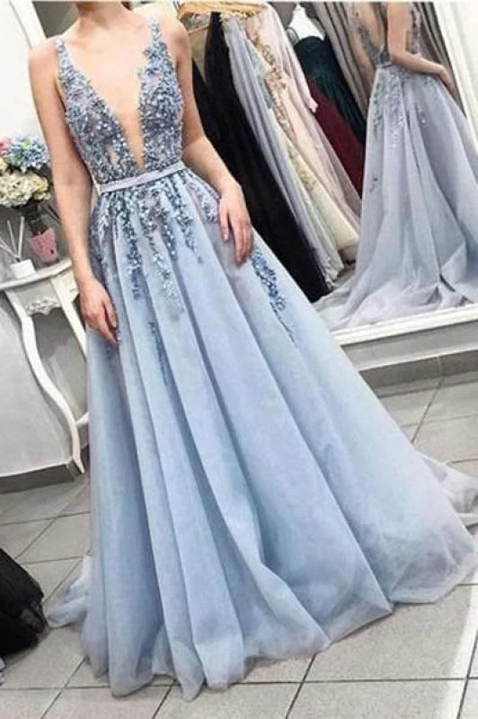 Model wearing a gorgeous V-neck tulle beaded backless long prom gown.