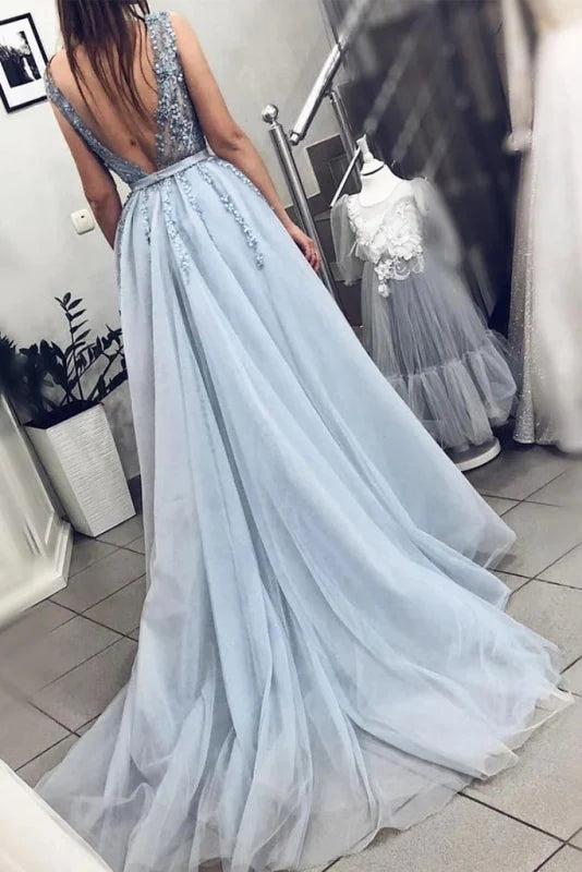 Close-up of the V-neck and intricate beading on a backless tulle gown.