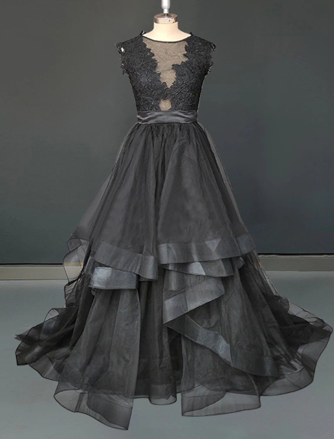 Gothic A-line wedding dress with illusion neckline, lace appliques, and sweep train.