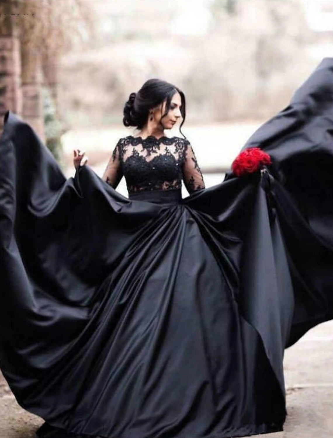 Gothic A-Line wedding dress with illusion neckline, long sleeves, and appliques.