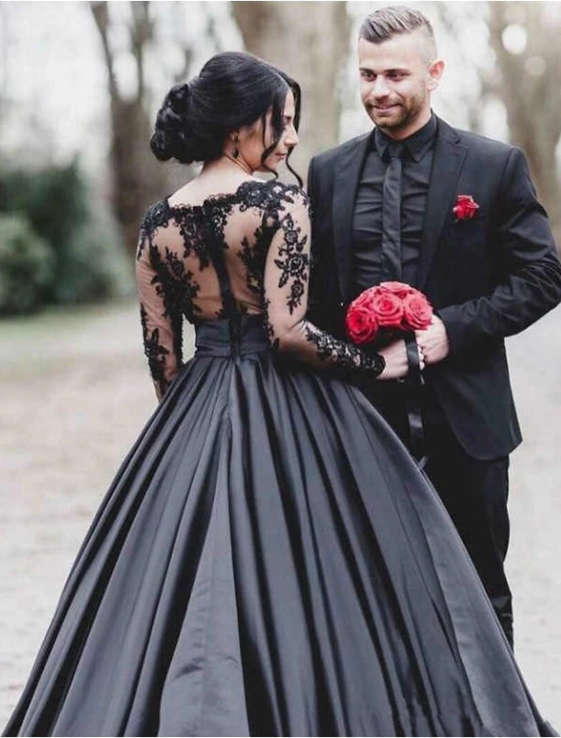 Floor-length satin bridal gown with intricate appliques and elegant silhouette.