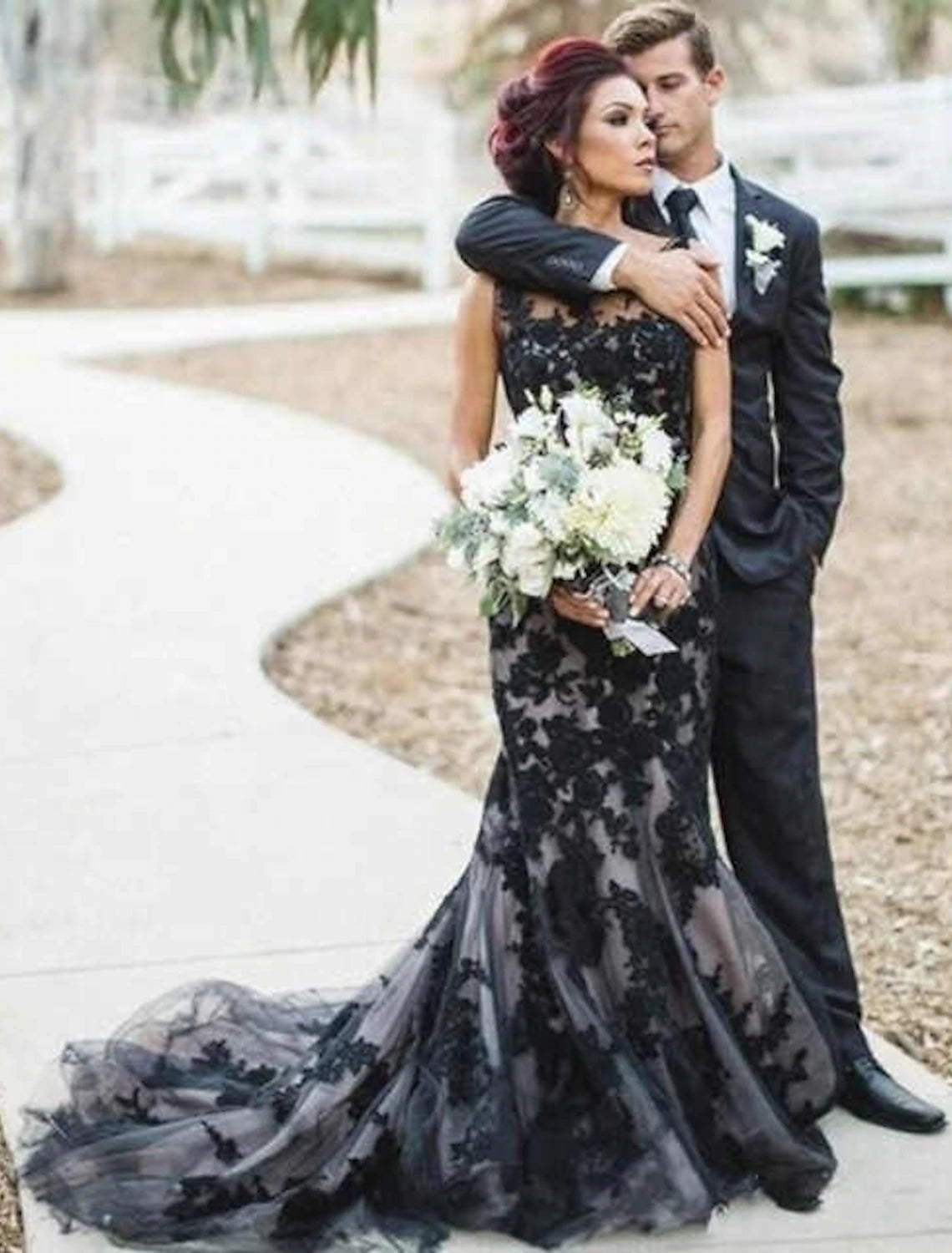 Gothic mermaid wedding dress with illusion neckline and appliques.